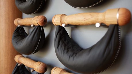 Aussicht auf Traumurlaub in Bad Tölz Schwarze gepolsterte Nackenstützen auf hölzernen Wandhalterungen