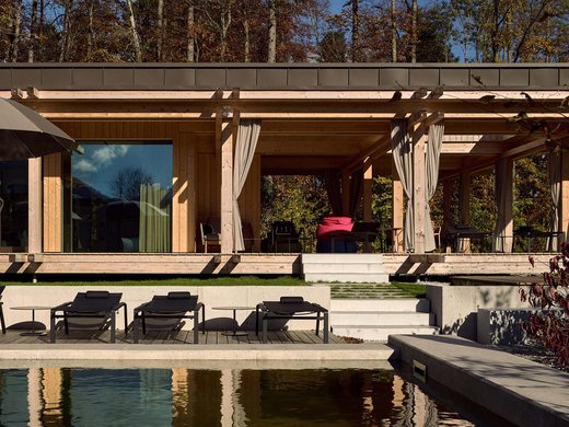 Your lounge for business & indulgence Modern wooden pavilion with pool and sun loungers in autumn setting