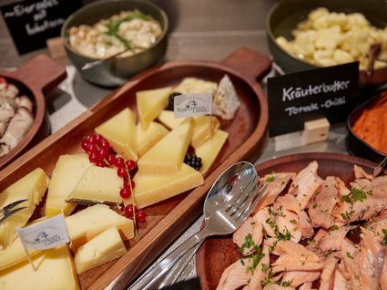 Bad Tölz: hotel with regional breakfast Assorted cheeses and smoked fish on wooden platters with herb butter