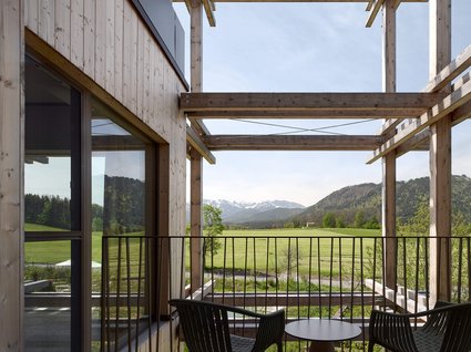 Your holiday in nature in Bavaria: Hotel BERGEBLICK Balcony with two chairs and table overlooking green fields and mountains
